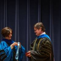 Provost Mili hands man a medal